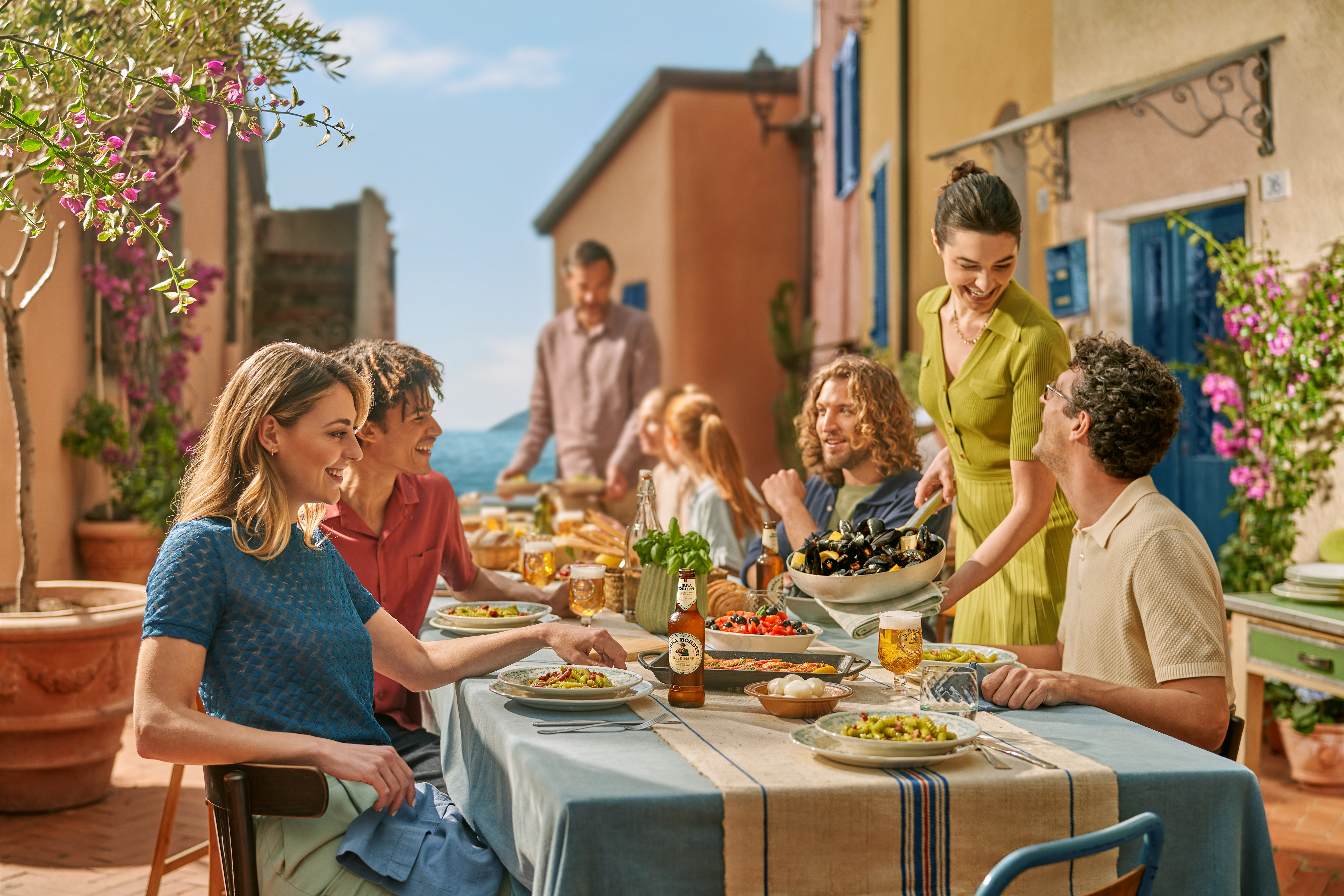 People sitting together at a table, sharing a meal.