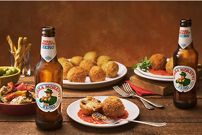 Arancini served on small plates alongside Birra Moretti Zero.